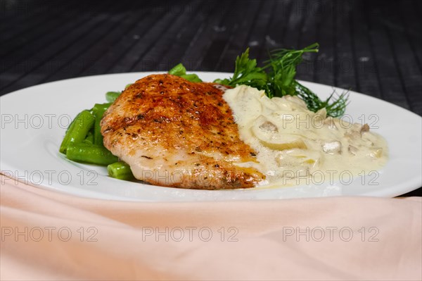 Closeup grilled steak and french green bean with creamy onion sauce