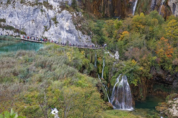 Hikers on wooden footbridge in Plitvice Lakes National Park