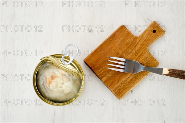 Top view of canned crab meat in open jar