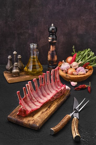 Fresh lamb ribs on the cutting board. Raw meat with garlic