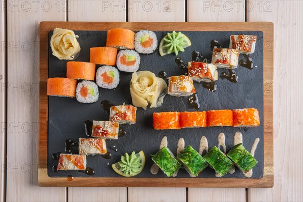 Big set of rolls served on stone plate