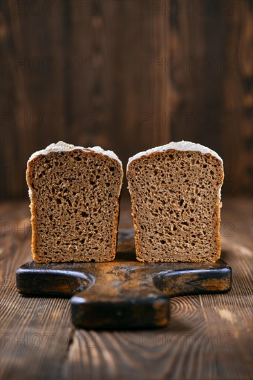 Loaf of artisan rye bread cut on half