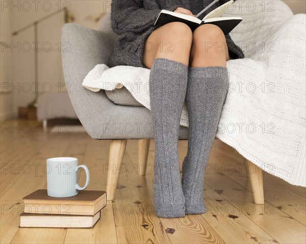 Woman wearing knee socks sitting armchair. Resolution and high quality beautiful photo