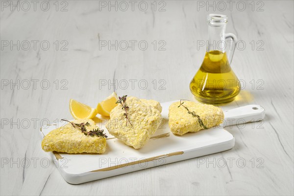 Semifinished frozen fish patty in breading for quick cooking