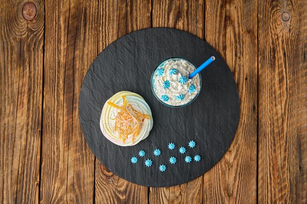 Overhead view of coffee with whipped cream and meringue cake