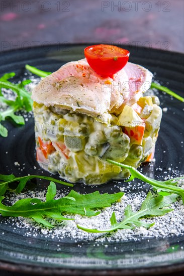 Olivier salad with slices of turkey