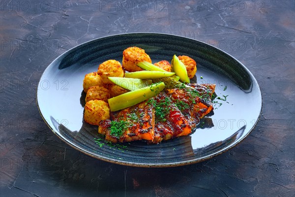 Grilled ribs with pickled cucumber and fried potato balls