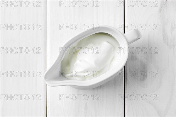 Top view of sour cream in ceramic gravy boat