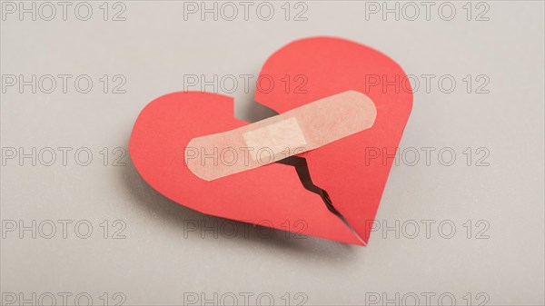 High angle broken heart with band aid