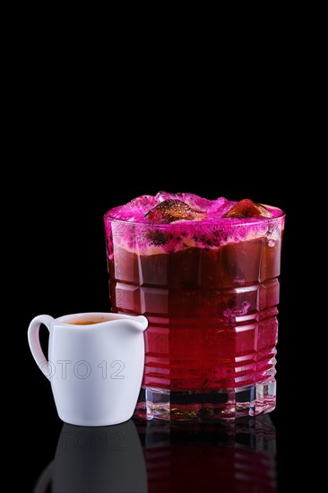 Espresso and tonic with dragon fruit isolated on black background