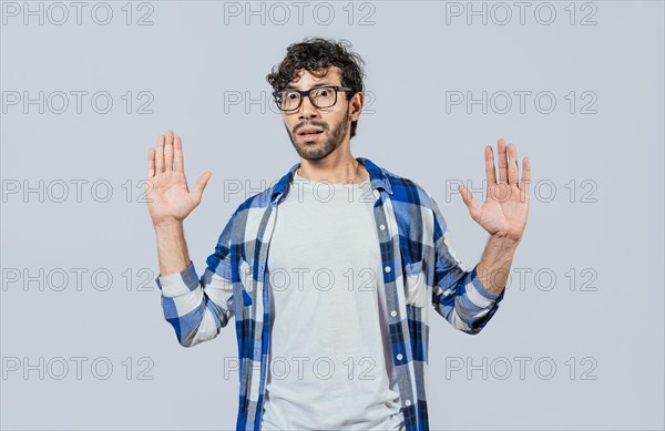Scared bearded man with raised hands in front. Scared and horrified man with raised palms