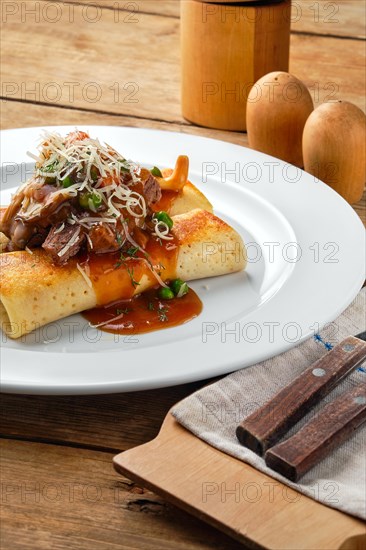 Close up view of thin pancakes stuffed with beef and mushrooms