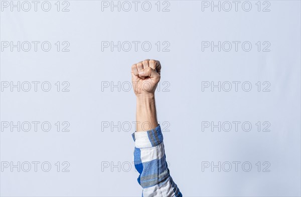 Hand gesturing the letter E in sign language on isolated background. Man hand gesturing letter E of alphabet isolated. Letters of the alphabet in sign language