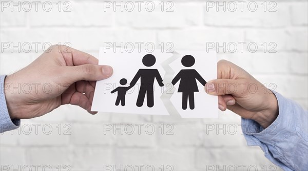 Couple holding family paper torn apart