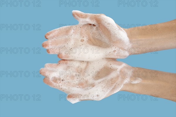 Top view person washing its hands with blue background. Resolution and high quality beautiful photo