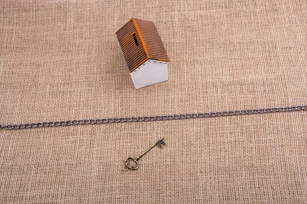 Retro key and a Model house beyond the chain on a canvas