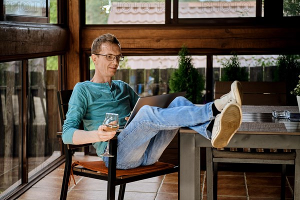 Middle aged man wearing glasses using laptop