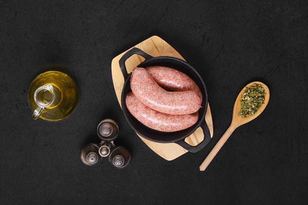 Top view of homemade classic raw beef sausage in cast iron skillet