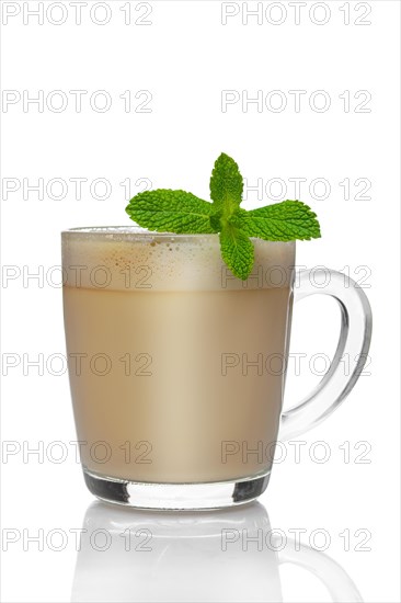 Transparent cup of cappuccino with mint liquor isolated on white