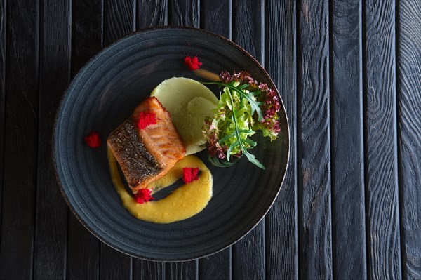 Fried salmon with mashed potato mixed with wasabi and decorated with flying fish roe