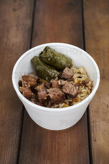 Soft focus photo of dolma and fried meat in take away plate