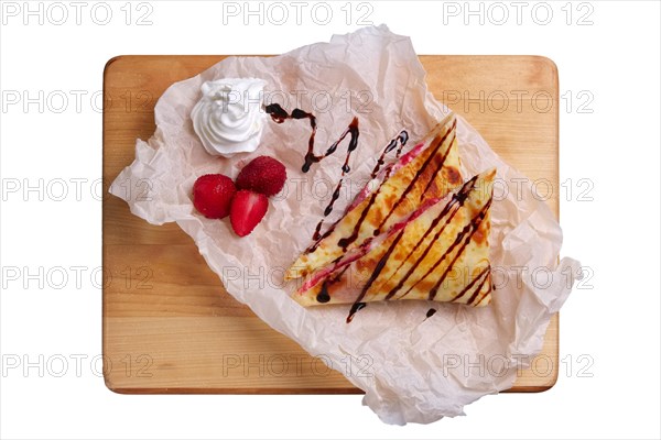 Thin pancakes stuffed with strawberry and soft cheese isolated on white