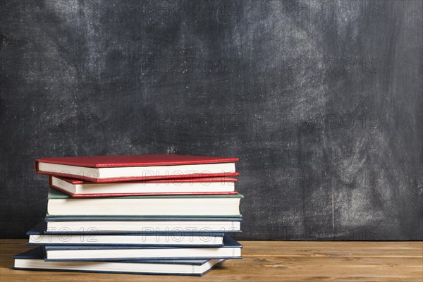 Colorful books front blackboard