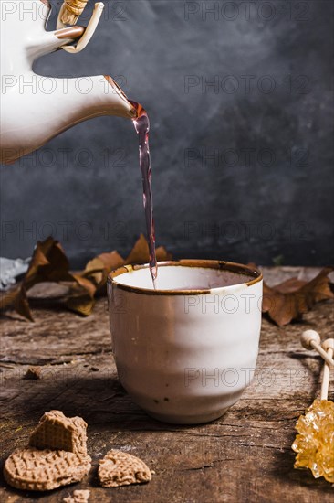 Front view tea being poured cup