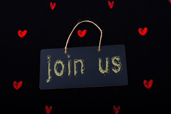 Rectangular shaped black notice board and red hearts on black background