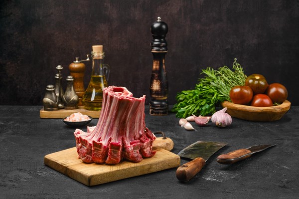 Raw lamb ribs rolled in the shape of crown on the table