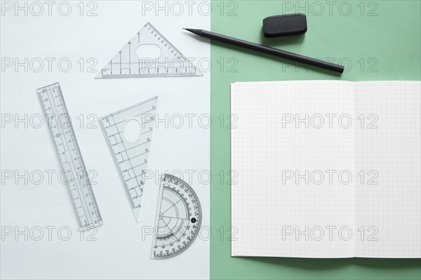 Elevated view geometric equipment notebook pencil eraser dual colorful background