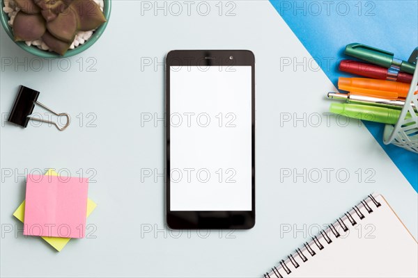 Smartphone surrounded by office supplies. Resolution and high quality beautiful photo