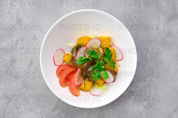 Top view of salad with fried chicken liver