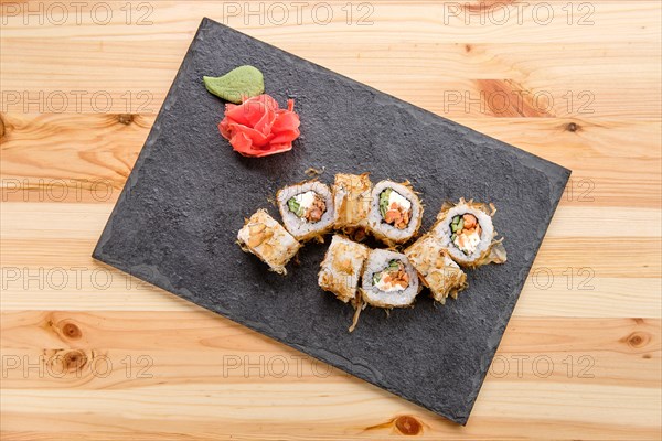 Smoked salmon rolls with cucumber on slate plate