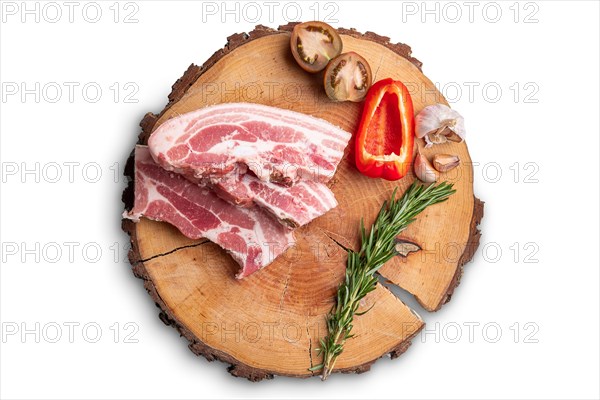 Raw fresh pork brisket slices on wooden cutting board isolated on white