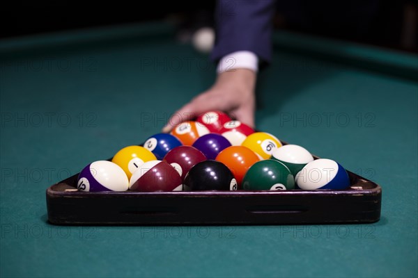 Close up guy arranging pool balls