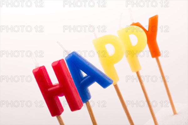 Color candles on sticks write the word happy