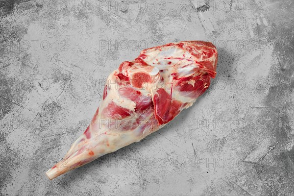 Raw lamb leg chump on shabby grey background