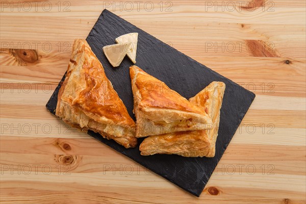 Puff pastry with cheese on slate plate