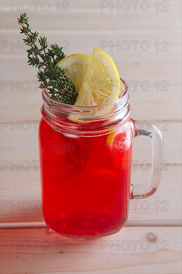 Cup of cranberry juice with citrus and rosemary