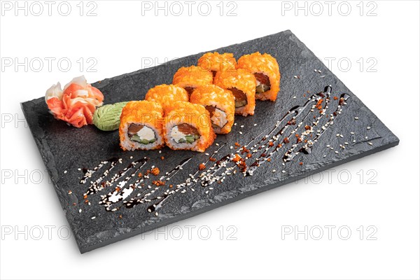 Set of rolls with wasabi and pickled ginger on stone serving board isolated on white