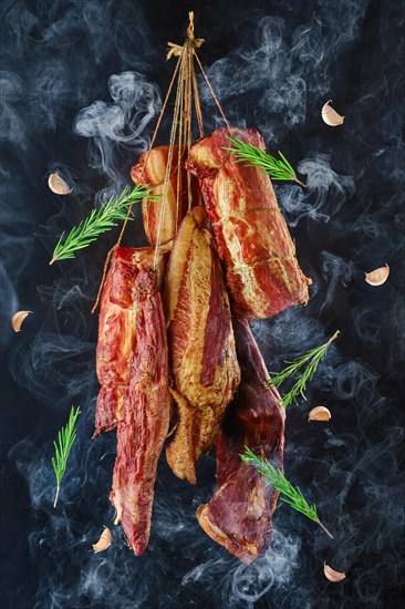 Composition of ssortment of air dried and smoked lamb and beef meat on hanger