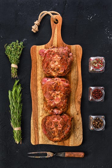 Top view of marinated lamb neck with seasoning and herbs