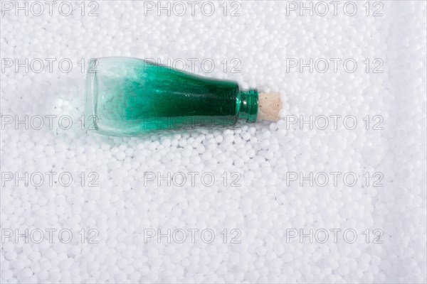 Empty bottle on little white polystyrene foam balls