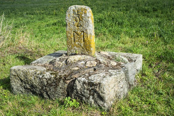 Old milestone on a country road at Roeddinge