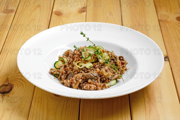 Boiled buckwheat with marinated mushrooms and fresh cucumber