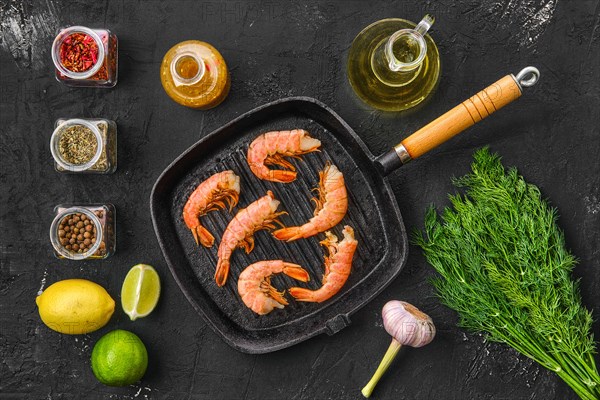 Top view of unpeeled shrimp in frying pan with spice