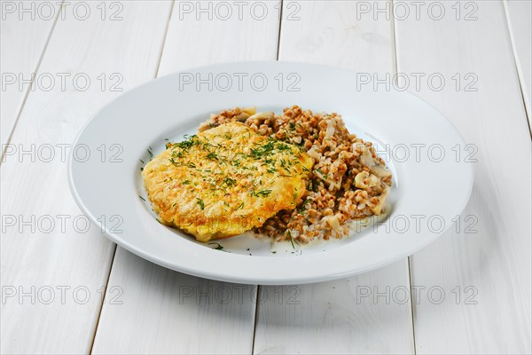 Chicken cutlet in breading with buckwheat and mushrooms