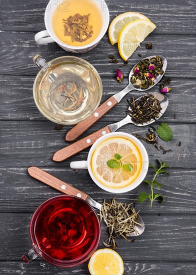 Cup with tea herbs beside