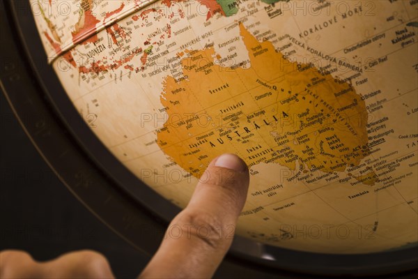 Person s finger pointing australia country globe